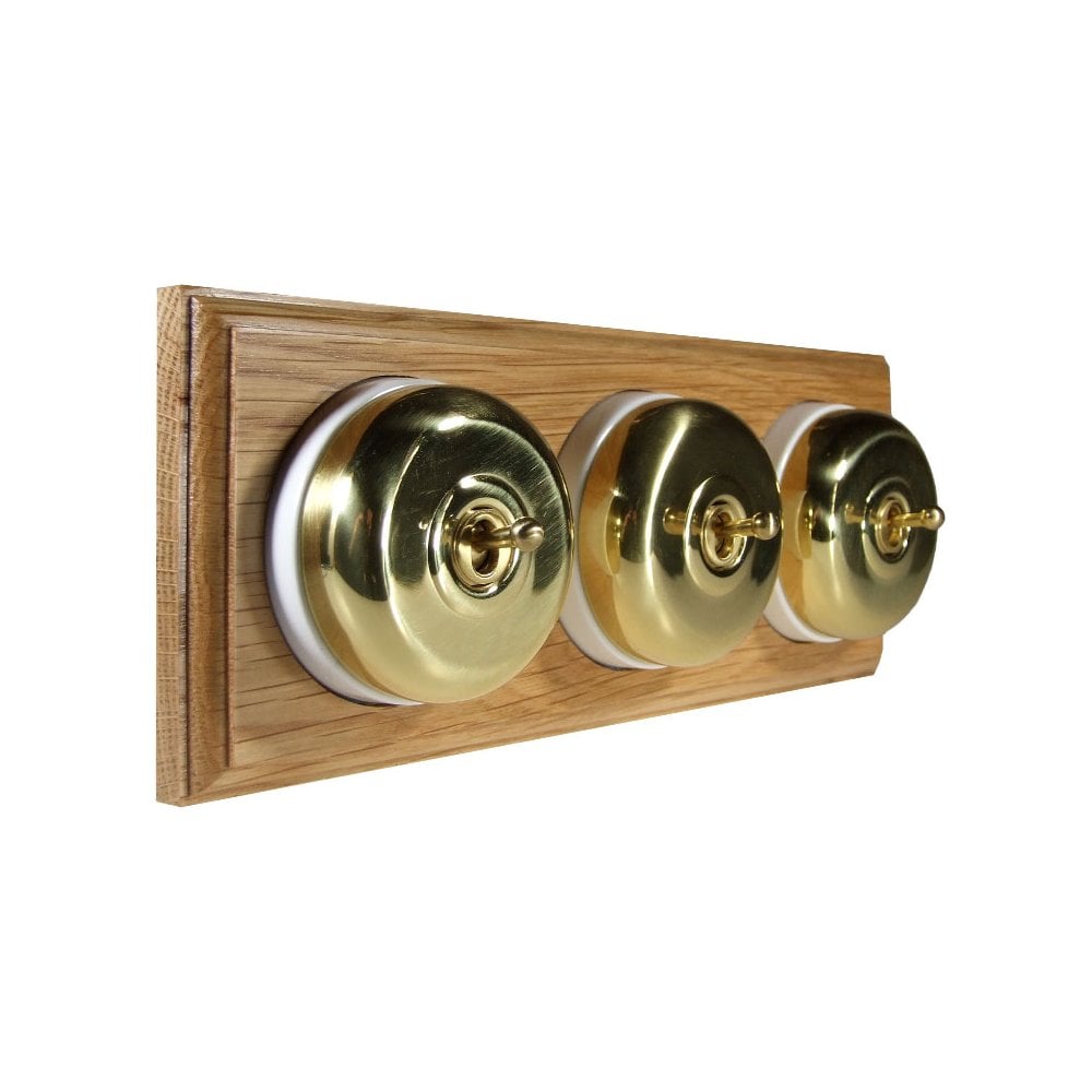 Switch to Wood's Dolly Light Switch Smooth Dome - 3 Gang Horizontal Polished Brass in Light Oak