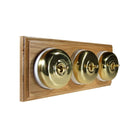 Switch to Wood's Dolly Light Switch Smooth Dome - 3 Gang Horizontal Polished Brass in Light Oak