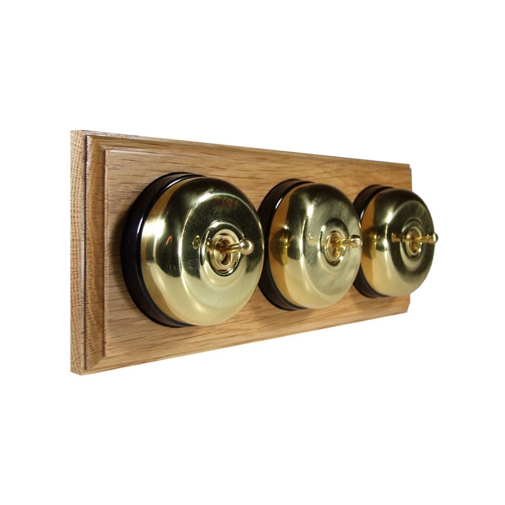 Switch to Wood's Dolly Light Switch Smooth Dome - 3 Gang Horizontal Polished Brass in Light Oak