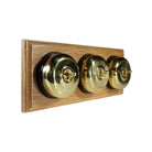 Switch to Wood's Dolly Light Switch Smooth Dome - 3 Gang Horizontal Polished Brass in Light Oak