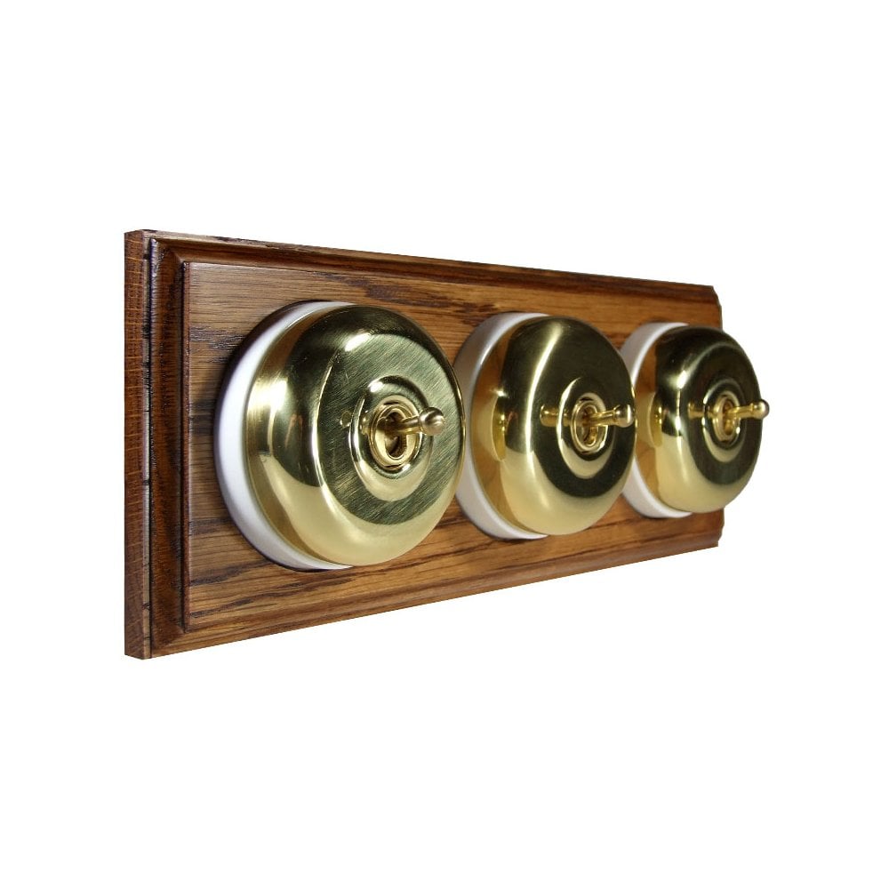Switch to Wood's Dolly Light Switch Smooth Dome - 3 Gang Horizontal Polished Brass in Medium Oak 