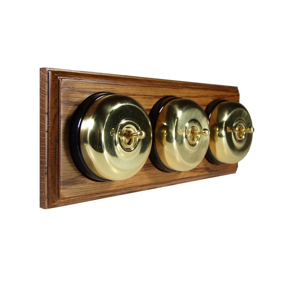 Switch to Wood's Dolly Light Switch Smooth Dome - 3 Gang Horizontal Polished Brass in Medium Oak 