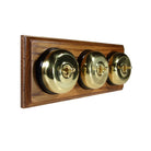 Switch to Wood's Dolly Light Switch Smooth Dome - 3 Gang Horizontal Polished Brass in Medium Oak 
