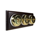 Switch to Wood's Dolly Light Switch Smooth Dome - 3 Gang Horizontal Polished Brass in Dark Oak