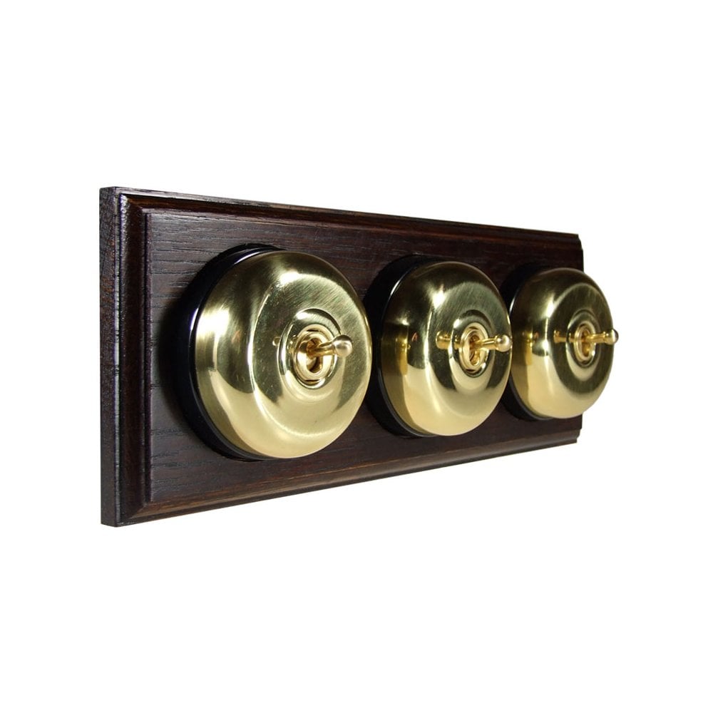 Switch to Wood's Dolly Light Switch Smooth Dome - 3 Gang Horizontal Polished Brass in Dark Oak