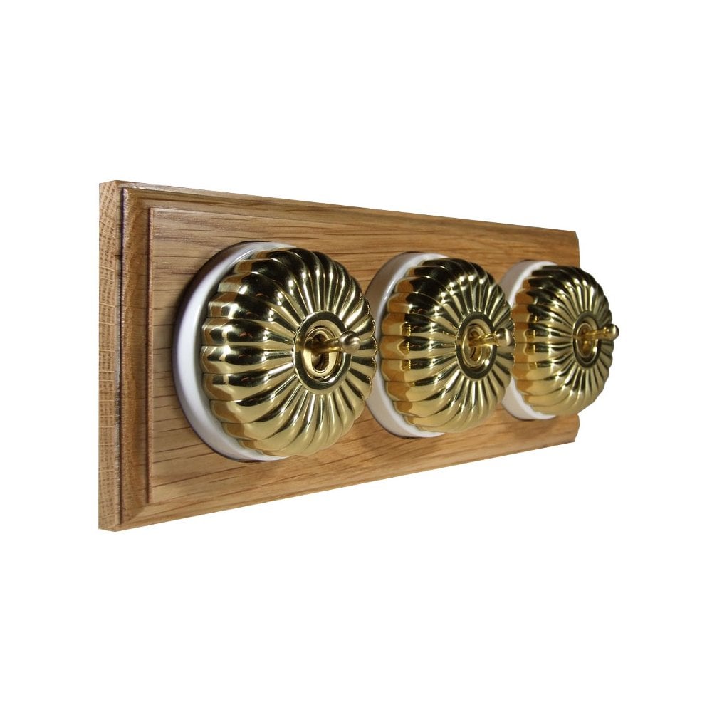 Switch to Wood's Dolly Light Switch Fluted Dome - 3 Gang Horizontal Polished Brass in Light Oak