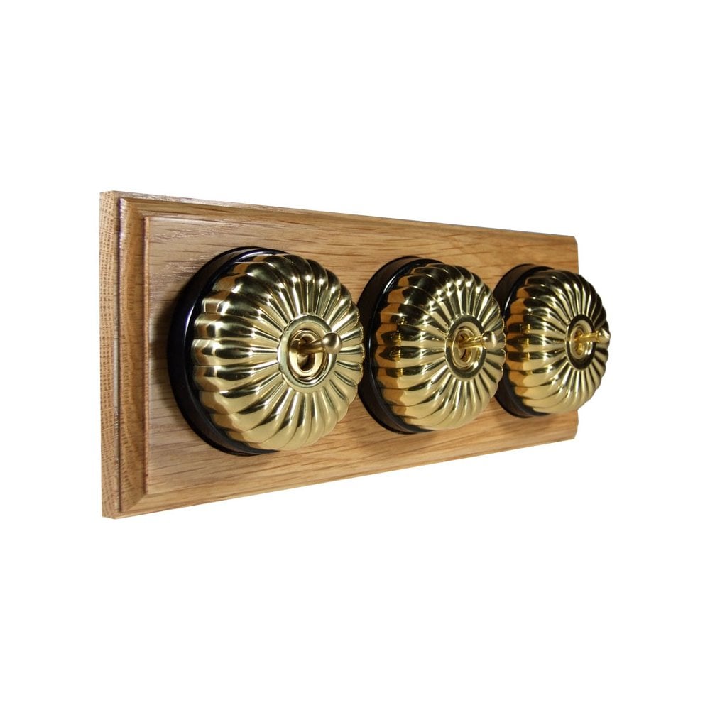Switch to Wood's Dolly Light Switch Fluted Dome - 3 Gang Horizontal Polished Brass in Light Oak