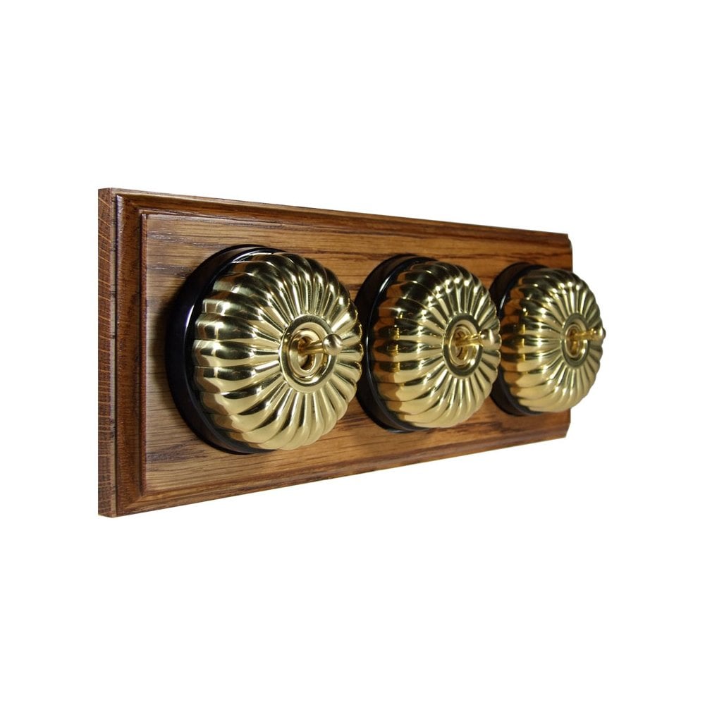 Switch to Wood's Dolly Light Switch Fluted Dome - 3 Gang Horizontal Polished Brass in Medium Oak 