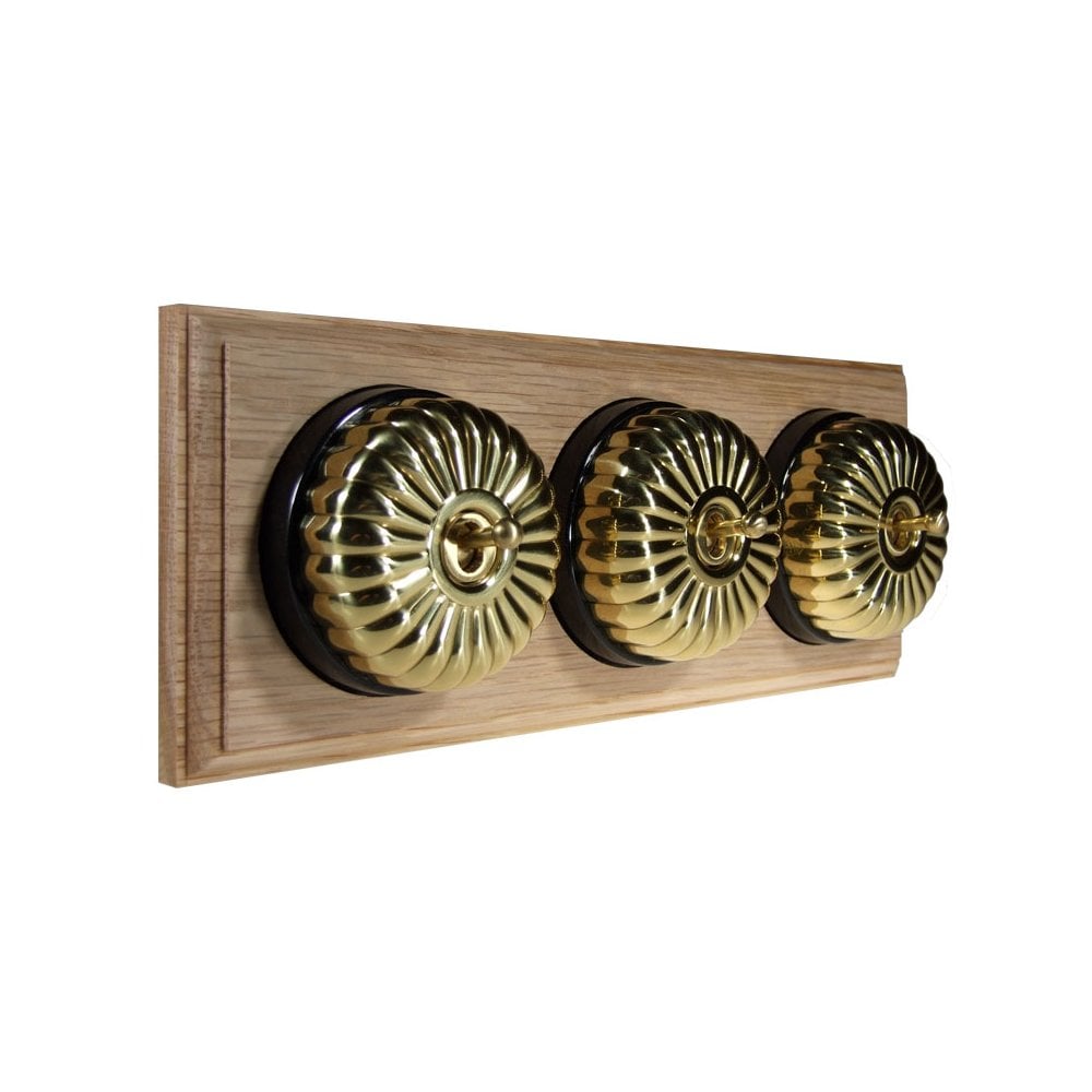 Switch to Wood's Dolly Light Switch Fluted Dome - 3 Gang Horizontal Polished Brass in Unfinished Oak