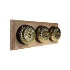 Switch to Wood's Dolly Light Switch Fluted Dome - 3 Gang Horizontal Polished Brass in Unfinished Oak
