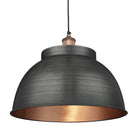 Industrial-style pendant light with a brushed pewter exterior and a warm copper interior, hanging from a black cord.