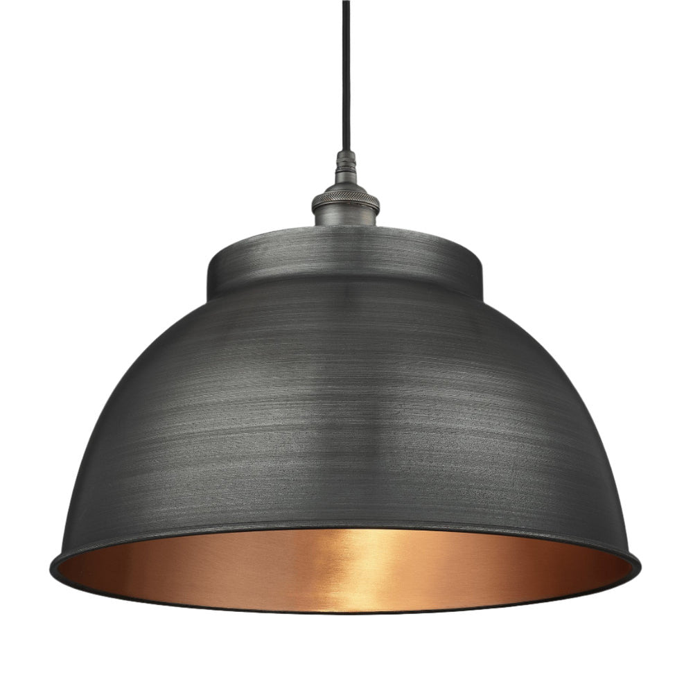 Industrial-style pendant light with a brushed pewter exterior and a warm copper interior, hanging from a black cord.