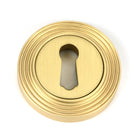 From The Anvil's Satin Brass Round Escutcheon
