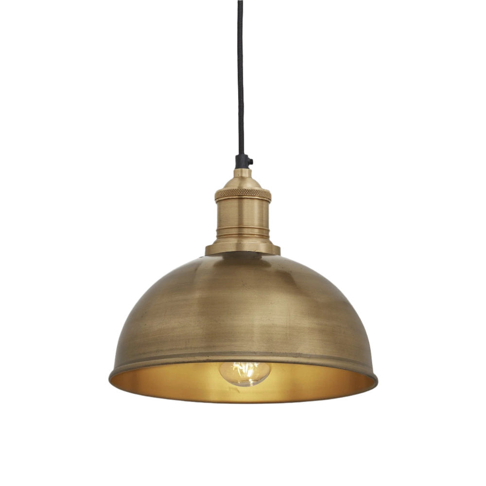 Industrial-style pendant light with a brushed brass exterior, hanging from a brown cord.