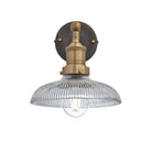 Industrial-style pendant light with a glass dome with a brass holder.