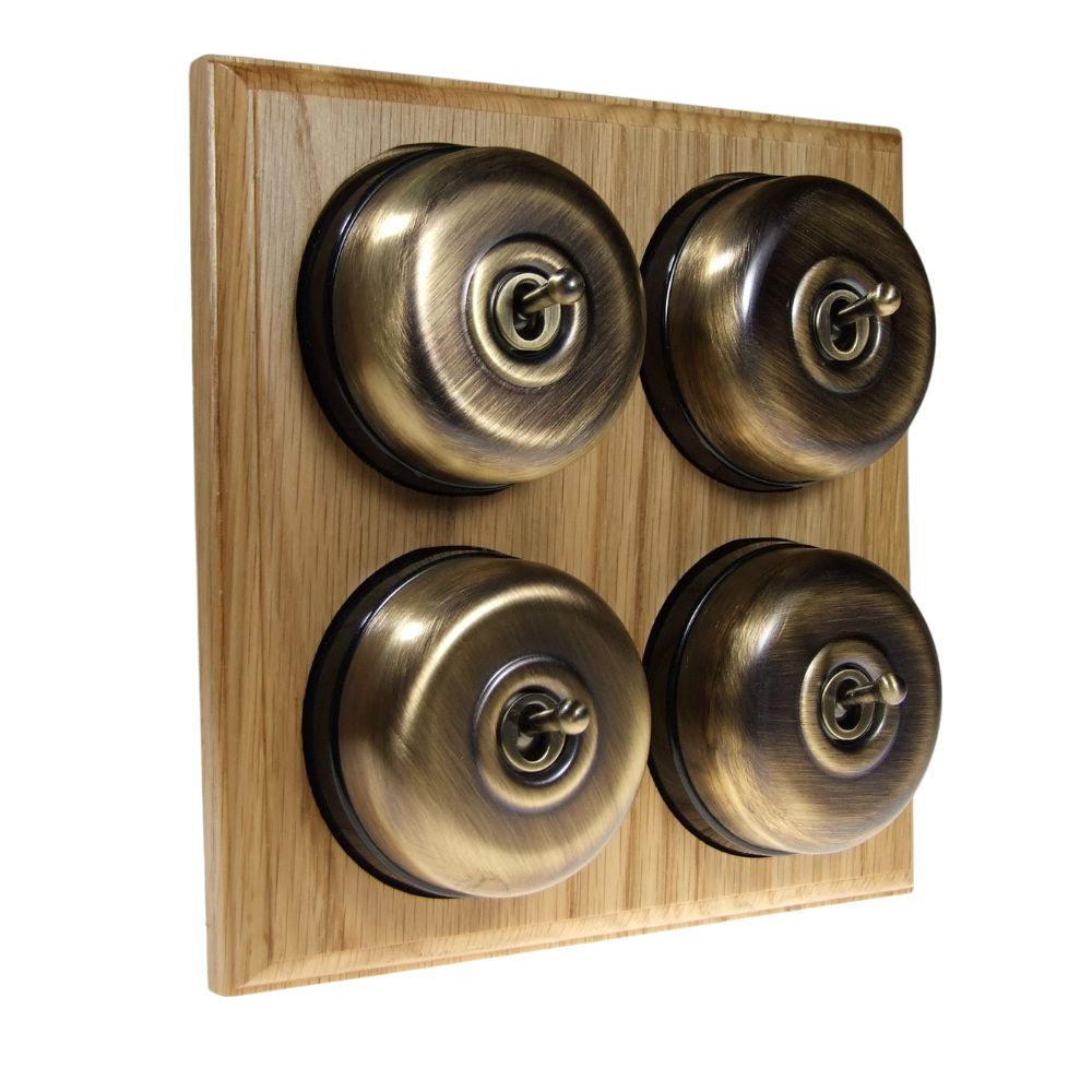 Switch to Wood's Dolly Light Switch Smooth Dome - 4 Gang Horizontal Antique Brass in Light Oak