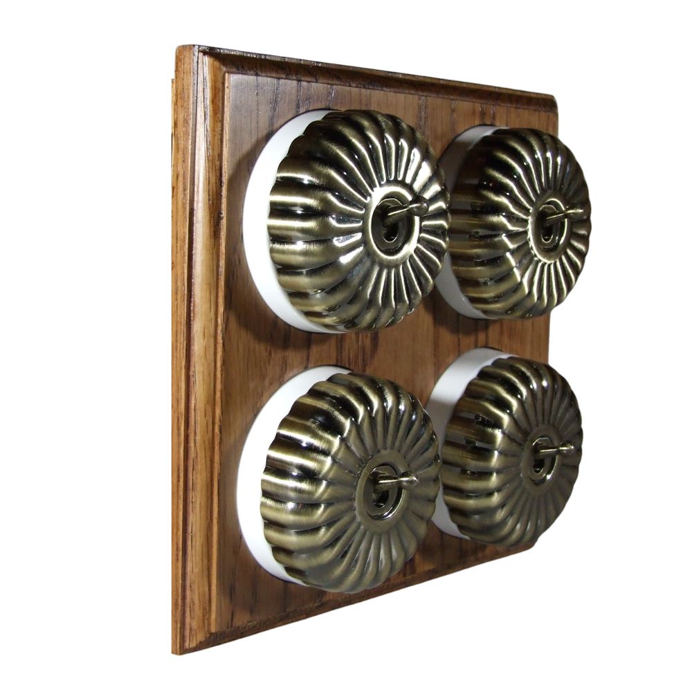 Switch to Wood's Dolly Light Switch Fluted Dome - 4 Gang Horizontal Antique Brass in Medium Oak 