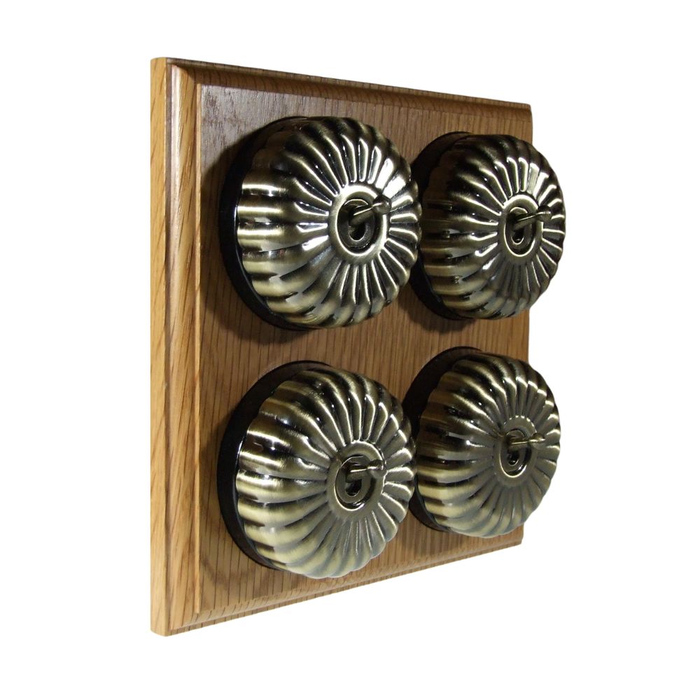 Switch to Wood's Dolly Light Switch Fluted Dome - 4 Gang Horizontal Antique Brass in Light Oak