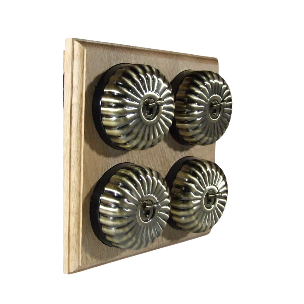 Switch to Wood's Dolly Light Switch Fluted Dome - 4 Gang Horizontal Antique Brass in Unfinished Oak