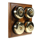 Switch to Wood's Dolly Light Switch Smooth Dome - 4 Gang Horizontal Polished Brass in Medium Oak 